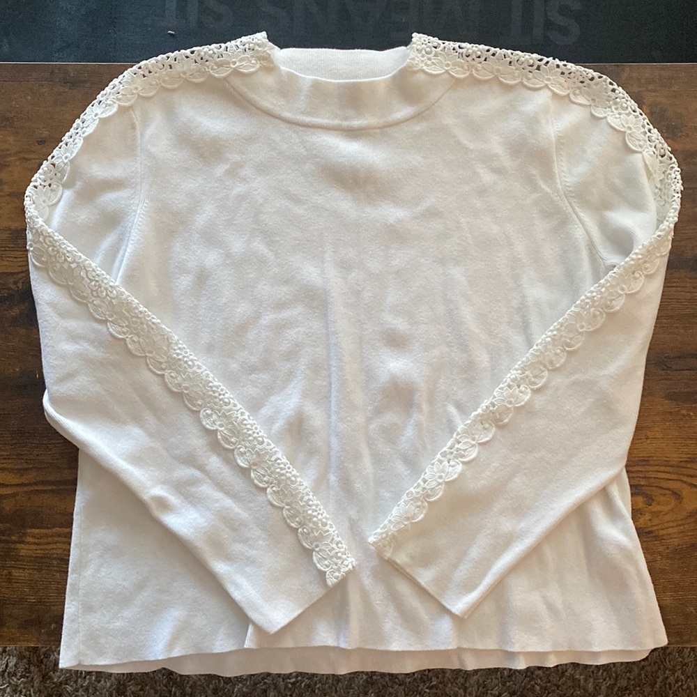 White sweater with lace detailing on sleeves